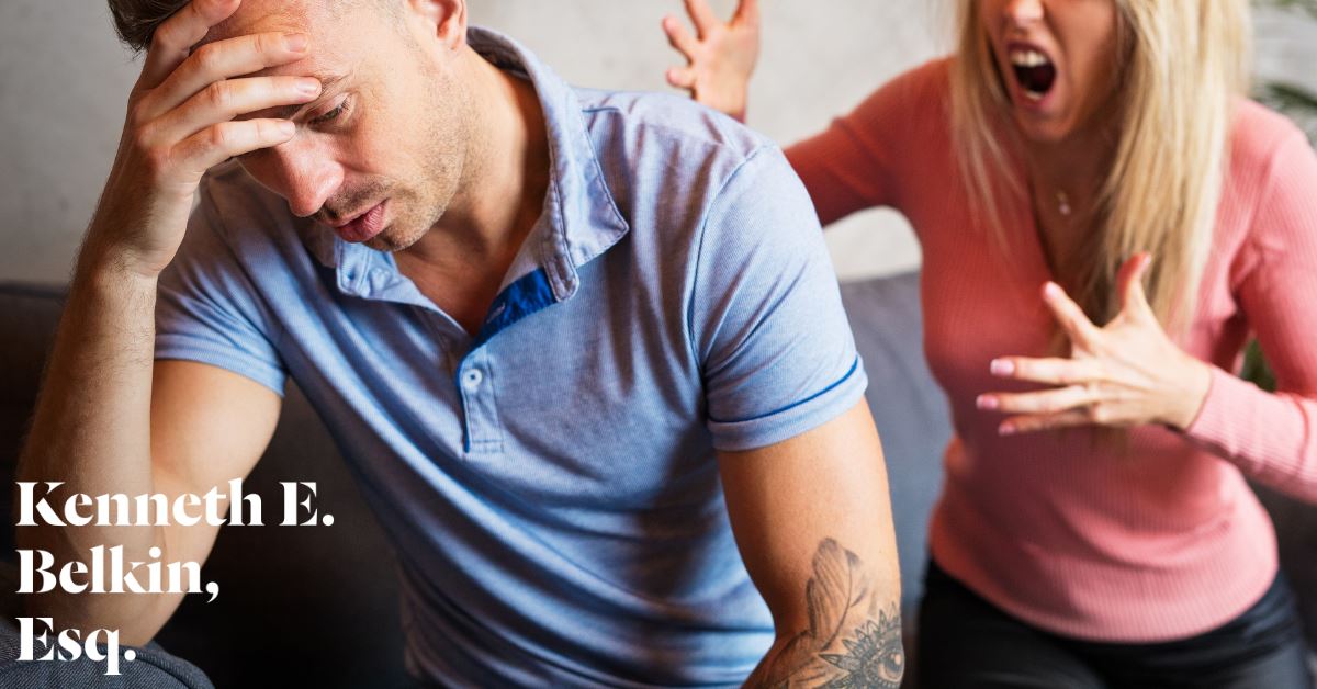 woman yelling at man who is facing away with his head in his hand